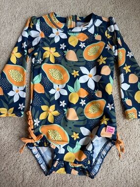 Ruffle Butts Navy Floral & Fruit Long Sleeve Swimsuit with Orange Accents